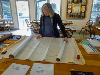 Zhanna investigates the mining maps in the museum.