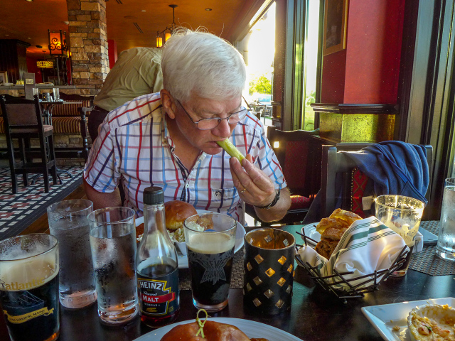 Dad is enjoying his food and Guinness