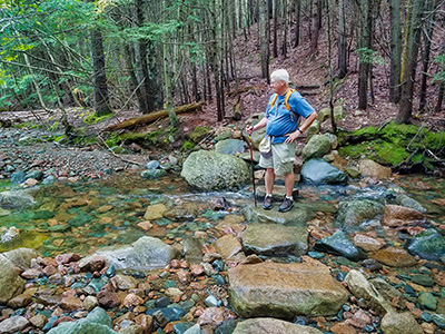 Dave stops at mid-crossing to admire the view on Kebo Brook.