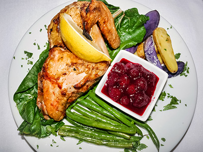 Organic Roasted Half Chicken with roasted potatoes and cranberry sauce