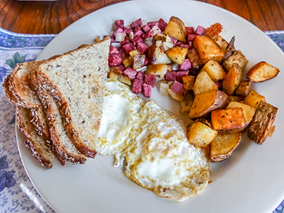 Fried Eggs with corned beef hash and roasted potatoes for Rich