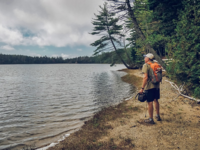 Rich studies the scene along the shore at Lower Hadlock Pond