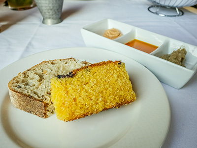 Multigrain bread and blueberry cornbread with condiments: white bean dip, chili oil and cinnamon honey butter