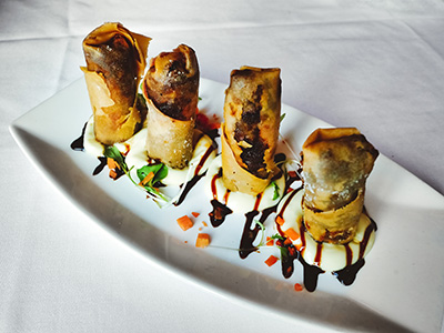 Local oyster and button mushroom spring rolls with truffle aioli and soy glaze