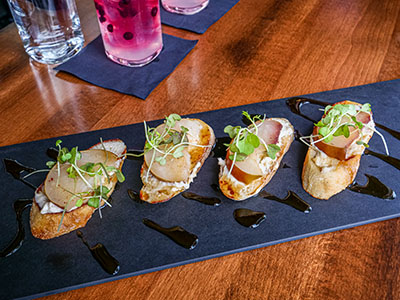 Poached pear bruschetta with grilled bread, whipped Gorgonzola, and balsamic vinegar