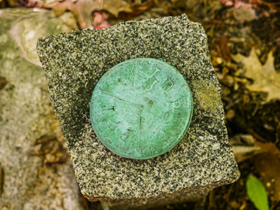 The disk on top of the granite post