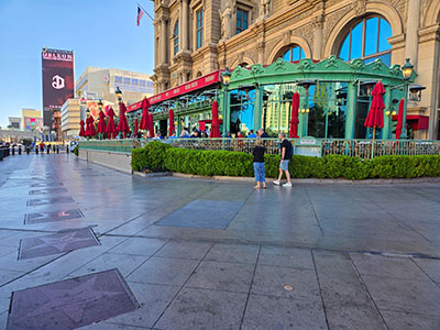 The disk is set in the sidewalk in front of the French bistro Mon Ami Gabi, very close to 052X