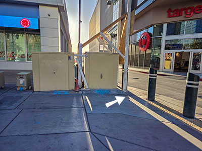 Eyelevel view of the disk at the outer edge of the sidewalk; looking E from Las Vegas Boulevard toward a driveway between Walgreen's and Target