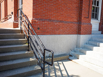 Eyelevel view of the disk set vertically into the wall of the post office