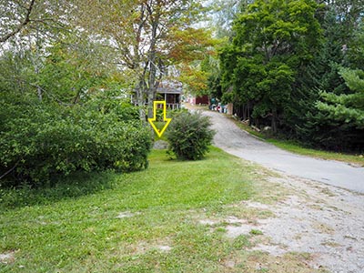 Looking W from Maine Route 102 (Main Street) toward the mark