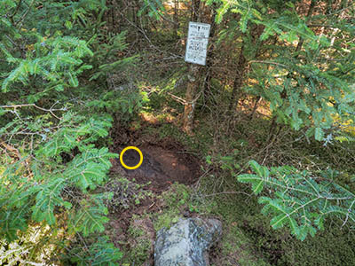 Eyelevel view of the bolt on the outcrop; witness post in background