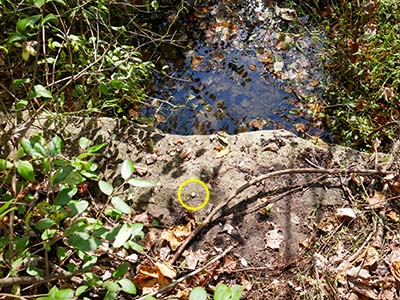 Eyelevel view of the rivet on the stone culvert.