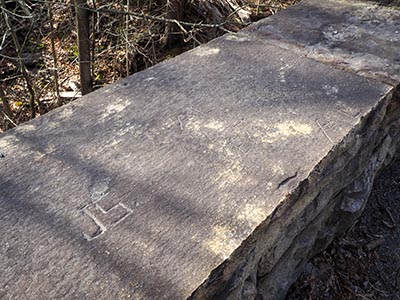 Carvings (but not the chiseled square) on top of the bridge wall