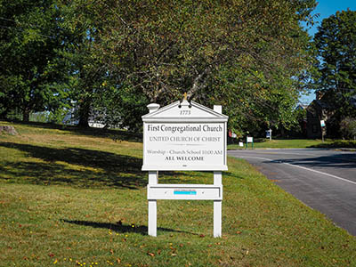 One of several signs indicating the name of the church