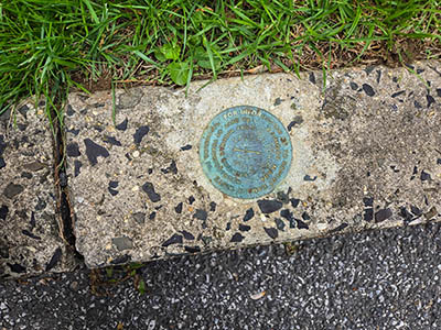The mark is set securely into the curb.