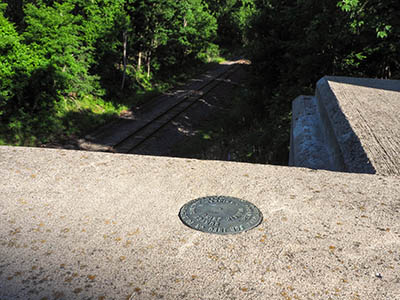 Eyelevel view of the mark on the bridge parapet wall